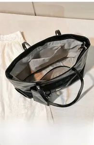 Detail view of large capacity interior with zip pocket and small card pouch attachment