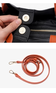 Detail view of contrast leather briefcase with magnetic buckle and adjustable strap