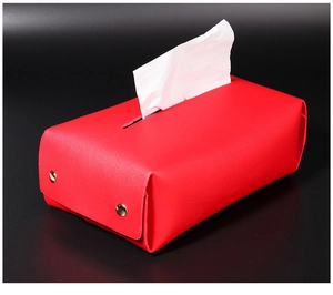 Close-up of red PU leather tissue box cover with gold snaps and white paper