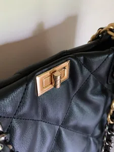 Close-up of black quilted leather tote bag featuring a premium gold-tone twist lock