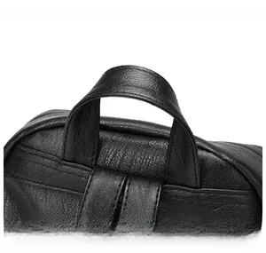 Close-up of the reinforced comfortable top handle with lychee texture on the black backpack
