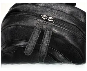 Macro detail of high-quality smooth dual zippers on black lychee grain leather backpack