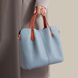 Foggy blue large tote bag with orange contrast handles and textured lychee leather