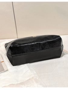 Detailed view of glossy black wax leather tote bag base with premium reinforced stitching