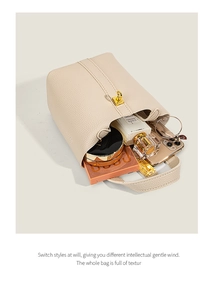 Top view of cream bucket bag showing spacious interior with cosmetic accessories