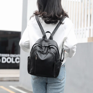 Outdoor shot of a woman wearing a black PU leather vintage backpack with multiple pockets