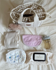Detailed view of canvas mommy bag featuring cute bear embroidery and inner drawstring liner