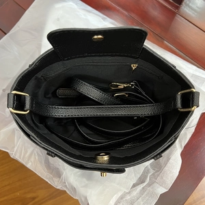 Interior view of black lychee leather bucket bag with zipper pocket and golden hardware