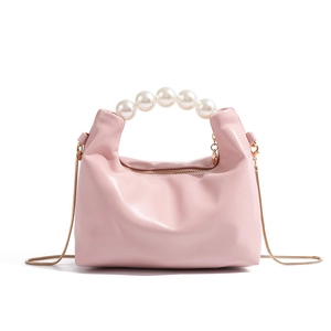 Pink dumpling handbag with pearl handle and golden chain, elegant minimalist style