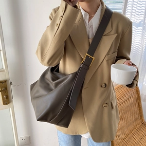 Minimalist large brown tote bag with wide shoulder strap and gold hardware for women
