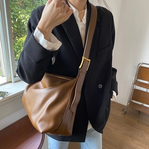 Minimalist brown leather tote bag with adjustable shoulder strap for casual daily use