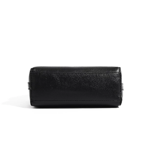 Detail view of the rectangular lychee pattern leather base with clean stitching on black bag