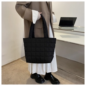 Detailed view of black quilted tote bag showing lightweight fabric and spacious capacity
