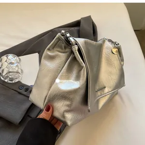 Detailed view of silver metallic pleated tote bag with sleek chain strap and pendant