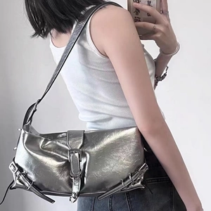 Metallic silver hobo shoulder bag with adjustable buckles and avant-garde punk style