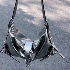 Silver metallic hobo bag with punk buckles and crinkled texture for edgy streetwear look