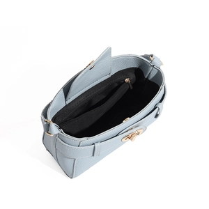 Detail of light blue lychee leather bag showing gold twist lock and inner zipper pocket