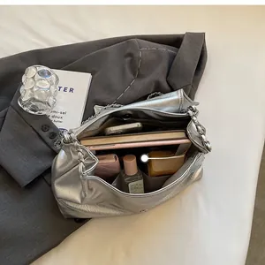 Top view showing the spacious interior of the silver chain tote bag with daily essentials