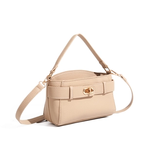 Close-up of beige lychee leather bag with elegant gold twist-lock buckle and fine texture