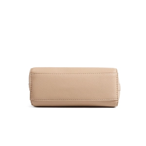 Close-up of beige lychee textured leather handbag bottom with reinforced stitching
