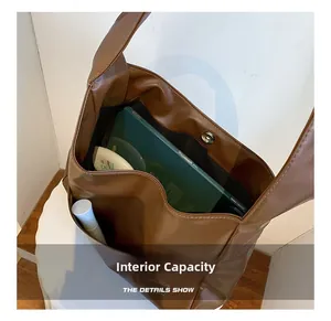 Interior view of brown tote bag showing spacious capacity for tablets and cosmetics