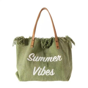Green canvas tote bag with Summer Vibes embroidery, tassels and brown leather handles