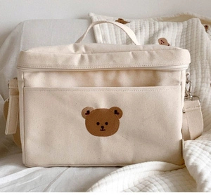 Detail of bear embroidery on canvas baby stroller organizer with shoulder strap