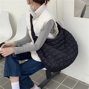 Detail of black quilted cloud bag showing the soft texture and spacious dumpling design