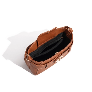 Internal view of brown pebble leather bag showing zipper compartment and white stitching