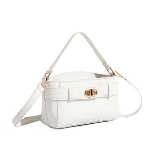 Detail view of white lychee grain leather texture and golden twist lock on Kelly handbag