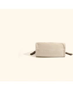 Detail view of the reinforced canvas base and durable brown webbing of the diaper bag