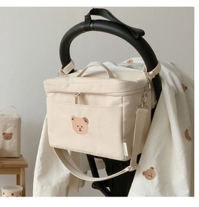 Detail of baby stroller organizer bag with cute bear embroidery and canvas material