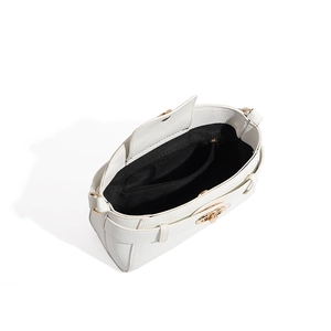Detail view of white pebbled leather handbag interior with black lining and zip pocket