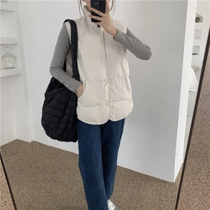 Mirror selfie showing a beige quilted cotton vest with stand collar and round hem style