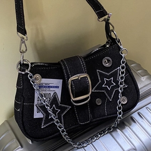 Detail of vintage star denim underarm bag with contrast stitching and silver chain strap