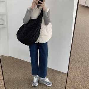 Minimalist black quilted cloud bag shown as a spacious crossbody shoulder bag for women