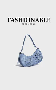 Detail shot of blue denim hobo bag featuring multiple zip pockets and buckled straps