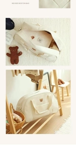 Detailed interior of a beige canvas diaper bag featuring a cute bear patch and large capacity