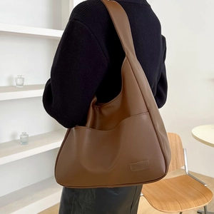 Deep brown matte leather hobo bag with large front pocket and spacious interior