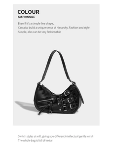 Detail view of black glossy leather underarm bag with decorative metal buckles and zippers