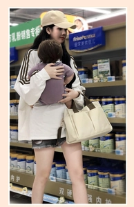 Practical multi-pocket canvas tote bag for mothers shown in a grocery shopping scenario