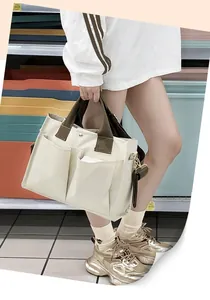 Practical multi-pocket canvas tote bag in beige with olive green contrast handles