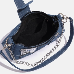 Internal view of blue denim star bag showing black lining and interior zipper pocket