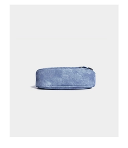 Detail view of the washed blue denim fabric texture and top zipper of the shoulder bag