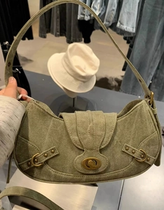Vue détaillée du sac besace vintage en toile vert armée avec fermoir pivotant et rivets