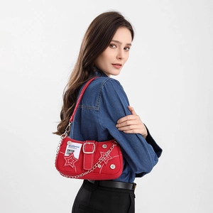 Star-patterned denim underarm bag with metal chain and red canvas moon shape design