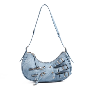 Detail of light blue hobo bag showing punk buckles and metallic zipper pockets