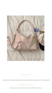Pink matte leather bag with decorative bow and zipper detail on white fabric background
