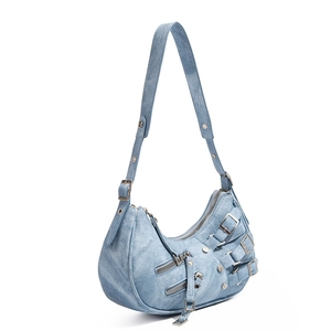 Detail view of light blue denim motorcycle hobo bag with silver studs and zippers