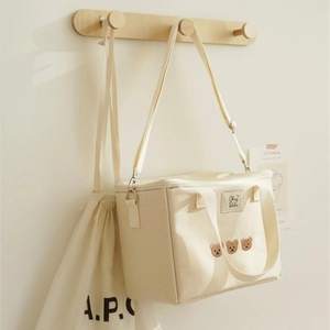Cream canvas insulated lunch bag with bear embroidery and adjustable shoulder strap